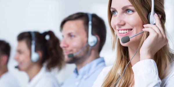 Smiling customer service representative talking with client